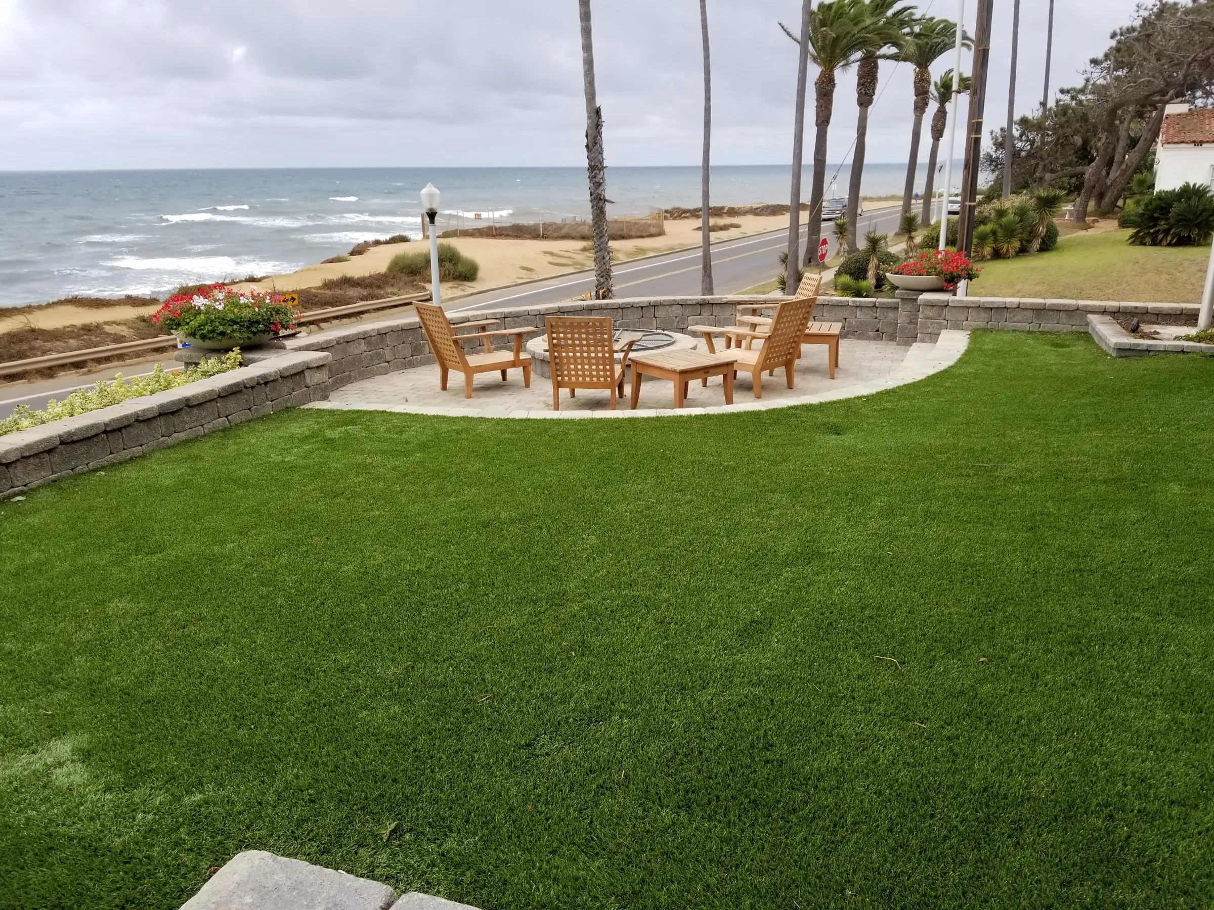 Artificial turf lawn beside a paver outdoor living area
