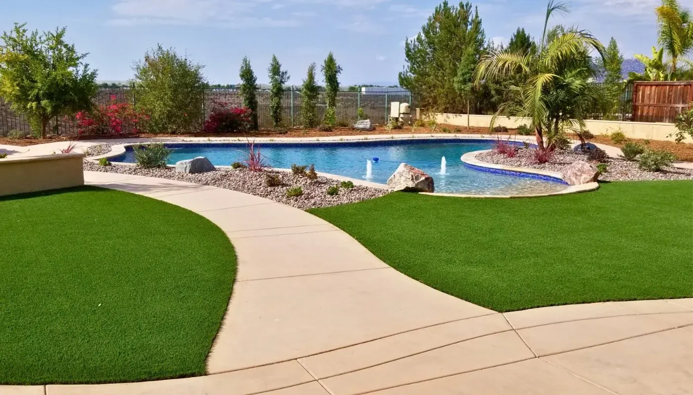 Poolside artificial turf with stone edging